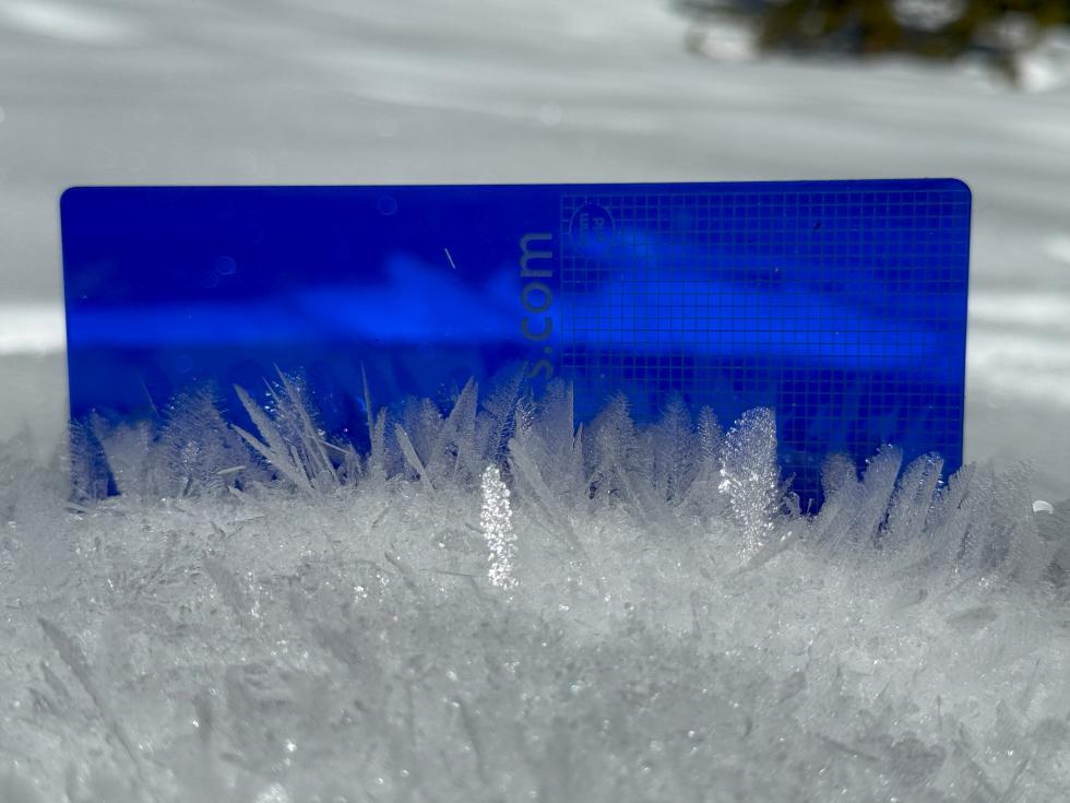  surface hoar crystals against a blue measurement grid. 