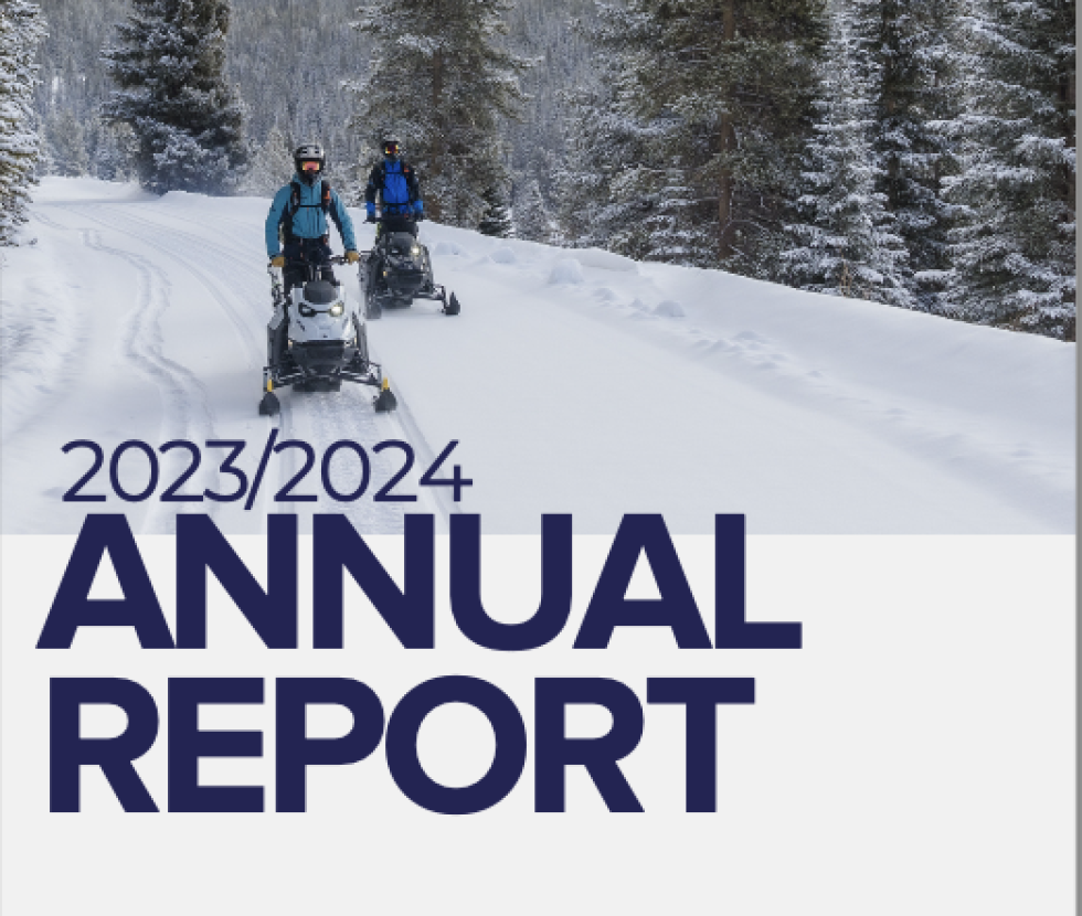 Annual Report text on top of an image of two forecasters snowmobiling